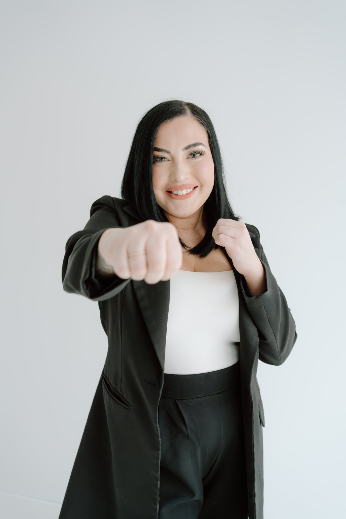 Jayci Wigle, Realtor with The Knight Group, throwing a playful punch toward the camera