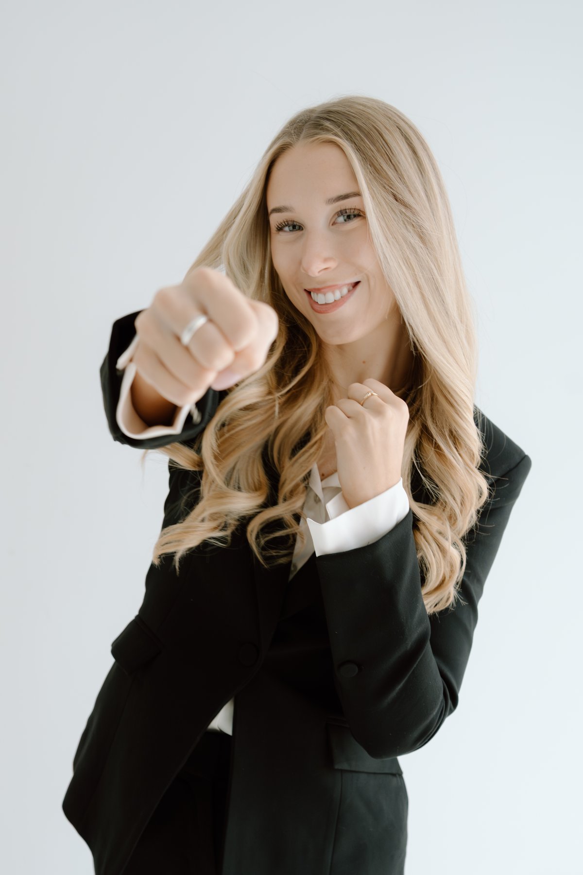Payton Prieur, Realtor with The Knight Group, throwing a playful punch toward the camera