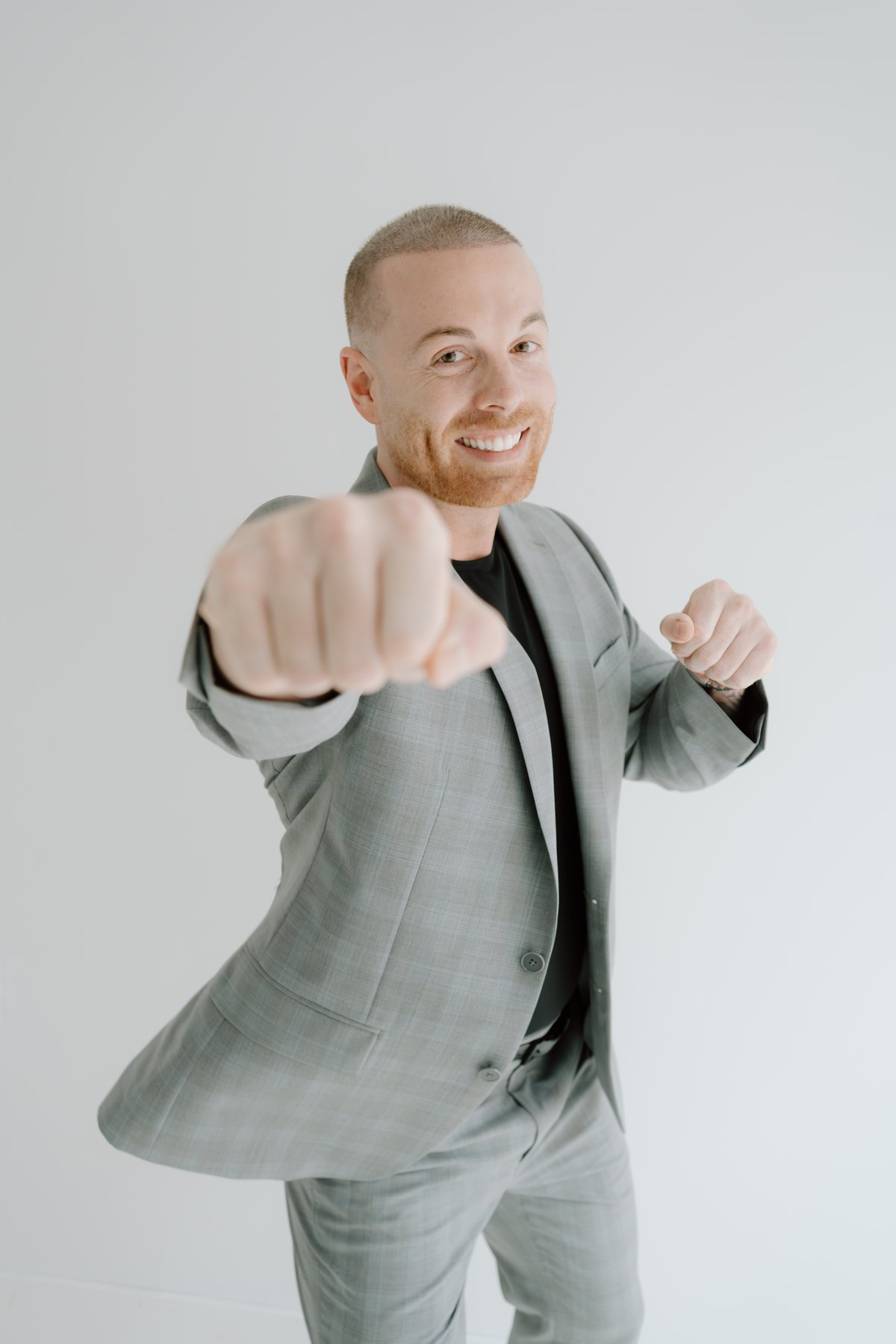 Tyler Knight, founder of The Knight Group, throwing a playful punch toward the camera