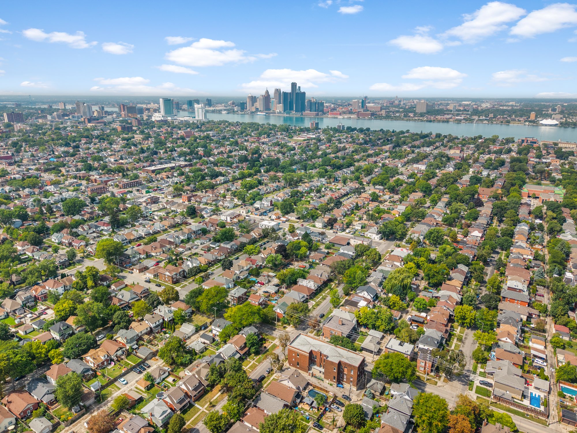 Aerial view of Windsor-Essex neighbourhoods with the Windsor and Detroit skylines along the river
